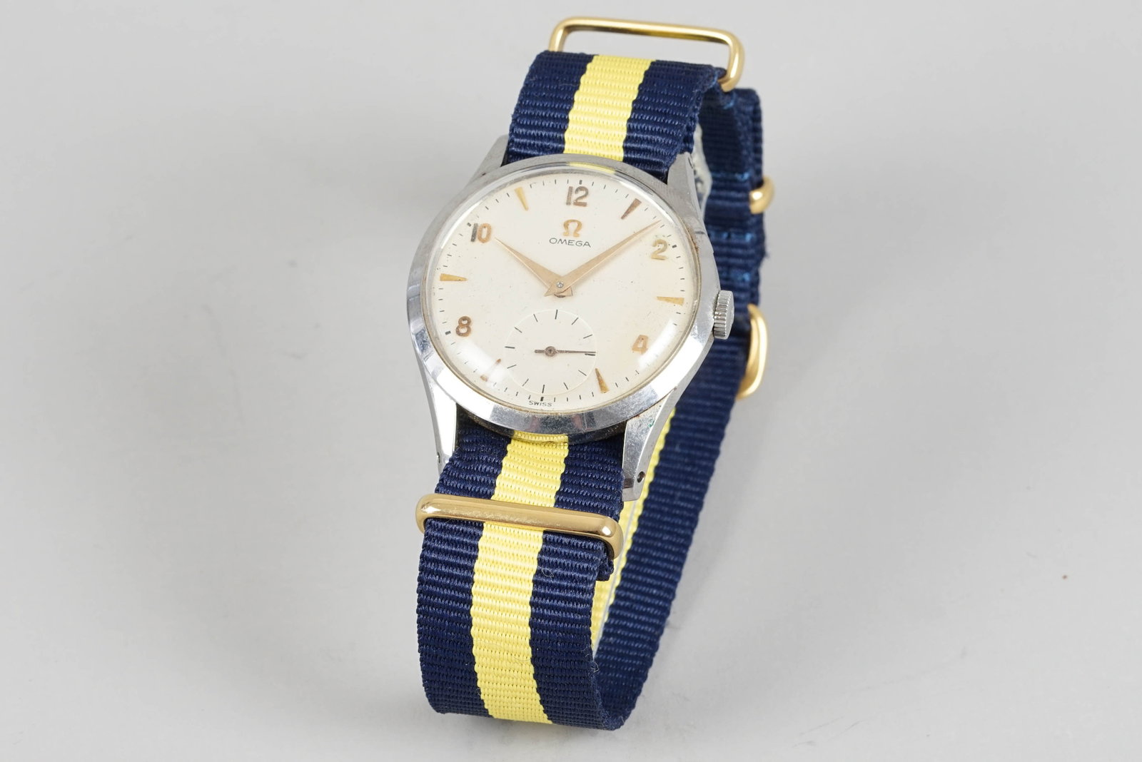 OMEGA WRISTWATCH: OMEGA WRISTWATCH DIAL: Circular silver dial with gold tone hour markers, dauphine hands, subsidiary dial CASE: 35mm stainless steel case omega crown, snap case back MOVEMENT: Manually wound movement