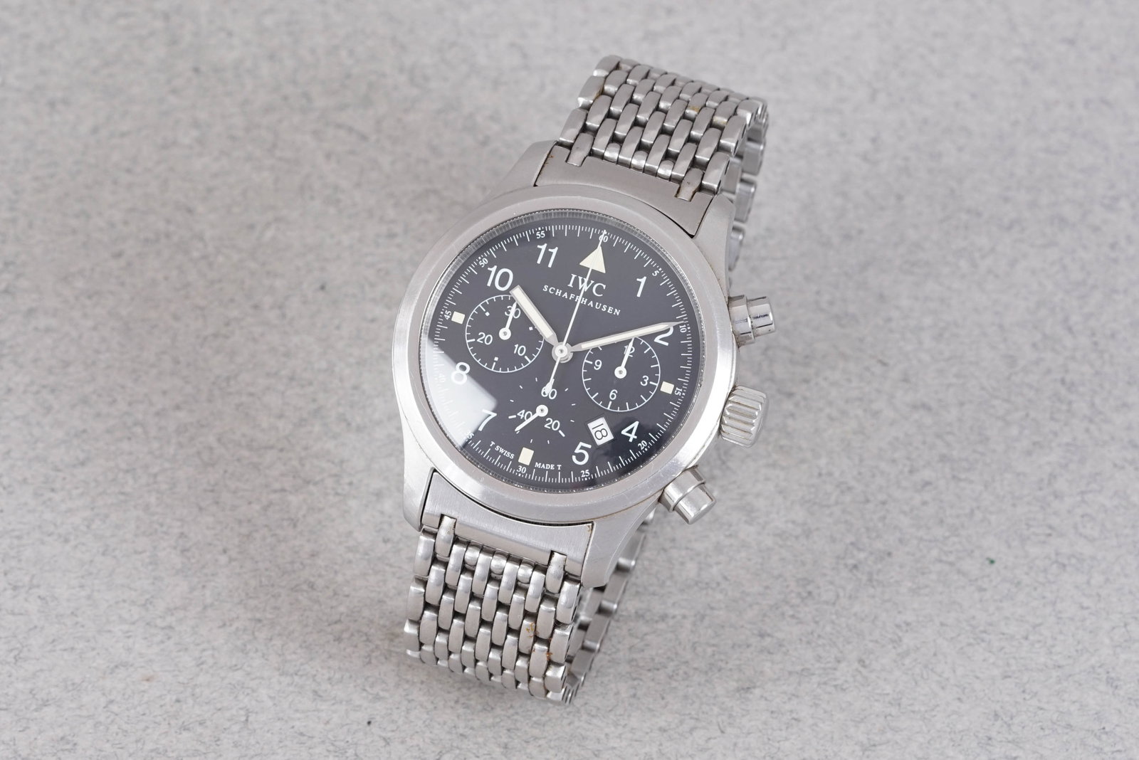 IWC SCHAFFHAUSEN CHRONOGRAPH DATE REF. IW374102: IWC SCHAFFHAUSEN CHRONOGRAPH DATE REF. IW374102, this watch is fitted with a circular dial with date window numerical hour markers and pencil hands. The 37mm steel case is fitted with a crown and a