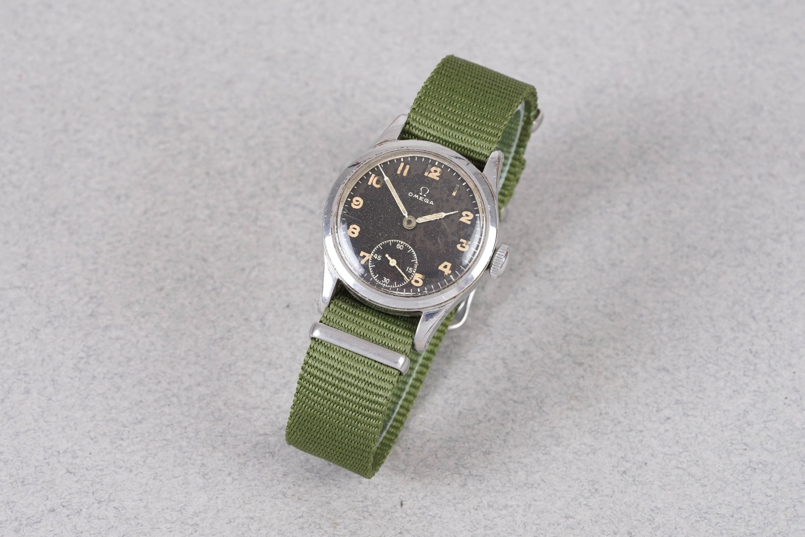 OMEGA MILITARY STYLE REF. 2165-3 CIRCA 1948: OMEGA MILITARY STYLE REF. 2165-3 CIRCA 1948, this watch is a ref. 2165-3 and is fitted with a black round dial with sub seconds, numbered hour markers and pencil hands. The 30mm steel case is fitted