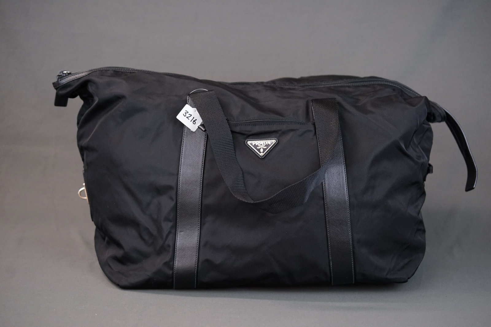 PRADA POCONO BLACK NYLON TOTE BAG: PRADA POCONO BLACK NYLON TOTE BAG DIMENSIONS: Width 42cm, height 37cm, depth 25cm COLOUR: black MATERIAL: nylon, leather trim ACCESSORIES: n/a CONDITION RANK: minor wear If you have any questions