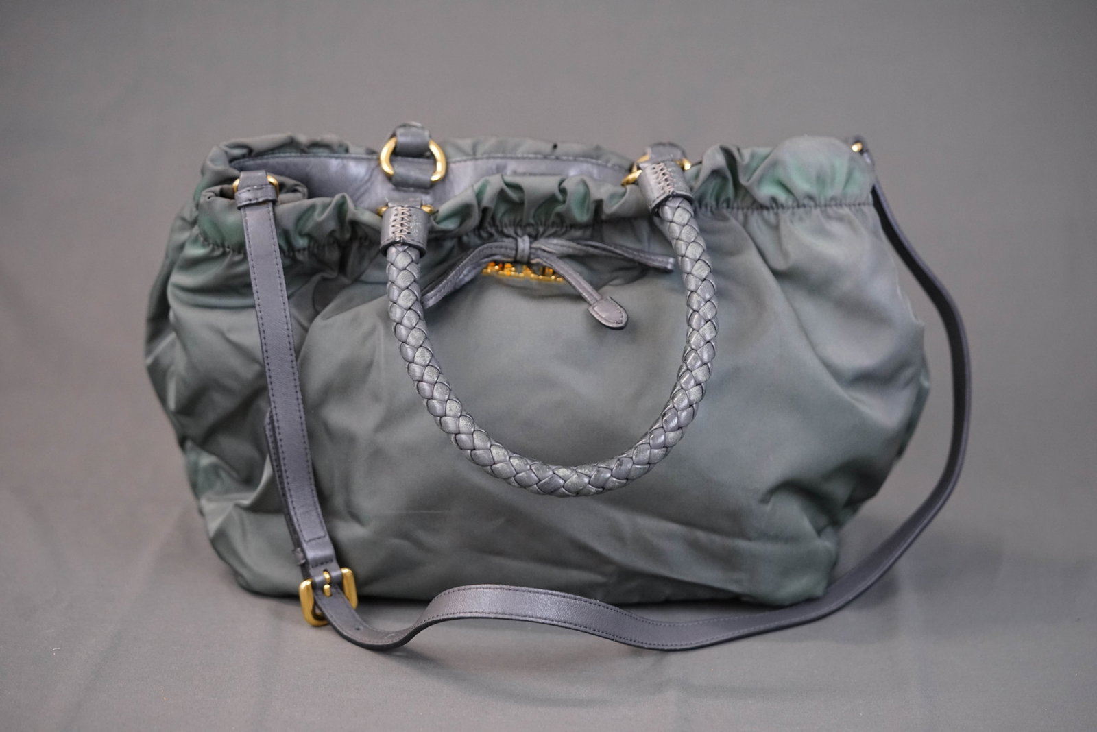 PRADA KHAKI NYLON HANDBAG: PRADA KHAKI NYLON HANDBAG DIMENSIONS: Width 27cm, height 24cm, depth 17cm COLOUR: two tone green MATERIAL: nylon, leather handles ACCESSORIES: shoulder strap CONDITION RANK: general wear commensurate