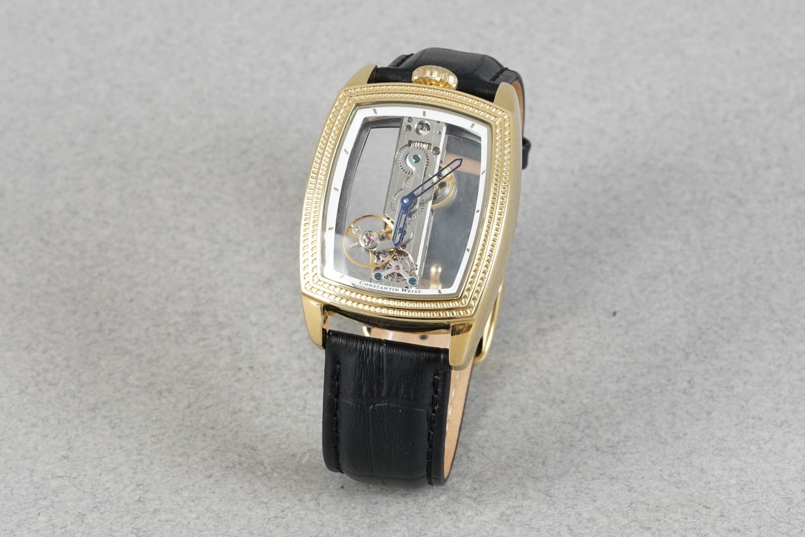 CONSTANTIN WEISZ SKELETON WRISTWATCH: CONSTANTIN WEISZ SKELETON WRISTWATCH DIAL: Skeleton dial CASE: 36x50mm gold plated case MOVEMENT: Mechanical movement BRACELET OR STRAP: Black leather ACCESSORIES: N/A If you have any questions