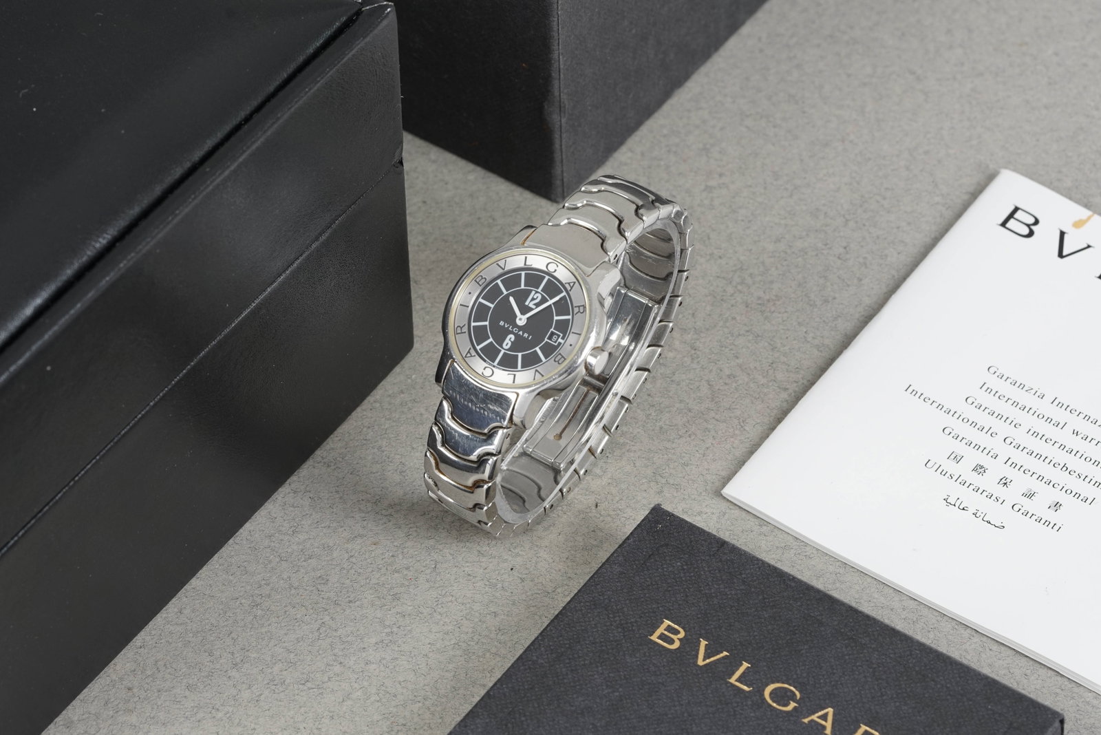 BULGARI SOLOTEMPO WRISTWATCH W/ BOX & GUARANTEE PAPERS REF. ST29: BULGARI SOLOTEMPO WRISTWATCH W/ BOX & GUARANTEE PAPERS REF. ST29 DIAL: Black dial with white hour markers, date window, snap case back CASE: 29mm stainless steel case, crown MOVEMENT: Quartz