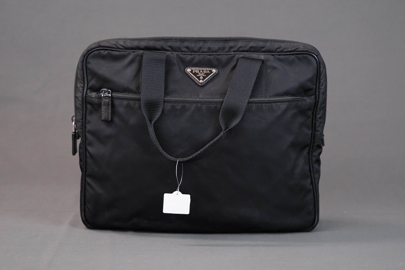 PRADA POCONO BLACK NYLON HANDBAG: PRADA POCONO BLACK NYLON HANDBAG DIMENSIONS: Width 33cm, height 27cm, depth 4cm COLOUR: black MATERIAL: nylon ACCESSORIES: CONDITION RANK: worn commensurate with age If you have any questions