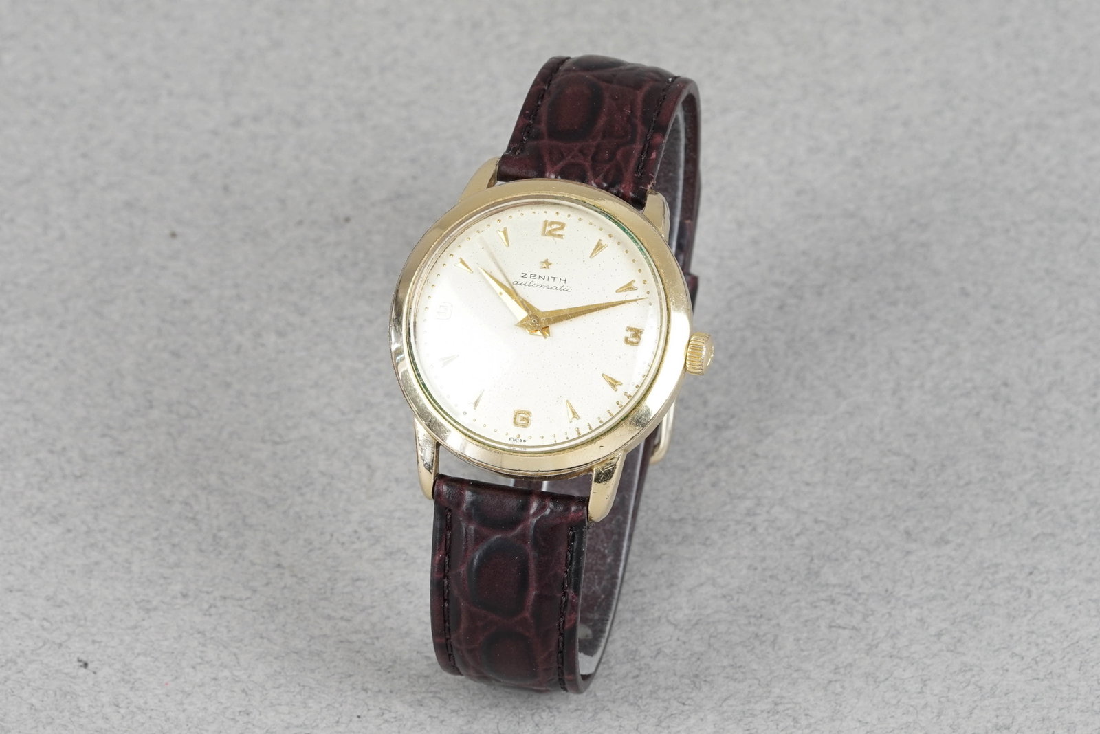 ZENITH AUTOMATIC BUMPER GOLD PLATED WRISTWATCH CIRCA 1956: ZENITH AUTOMATIC BUMPER GOLD PLATED WRISTWATCH CIRCA 1956 DIAL: Patina dial with indices, hands with Lume, Zenith marking CASE: Gold plated stainless steel case, screw-down case back MOVEMENT: