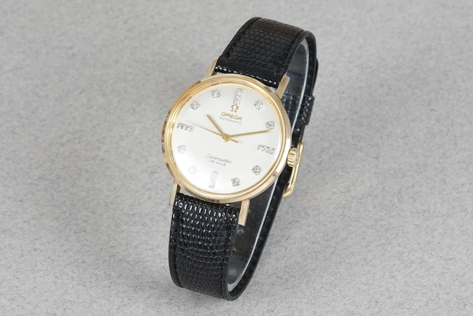 OMEGA SEAMASTER DIMAOND SET 14CT GOLD WRISTWATCH: OMEGA SEAMASTER DIAMOND SET 14CT GOLD WRISTWATCH DIAL: Dial with diamond set indices, gold hands CASE: 34mm 14ct yellow gold case, gold case back MOVEMENT: Automatic, Omega calibre BRACELET OR STRAP: