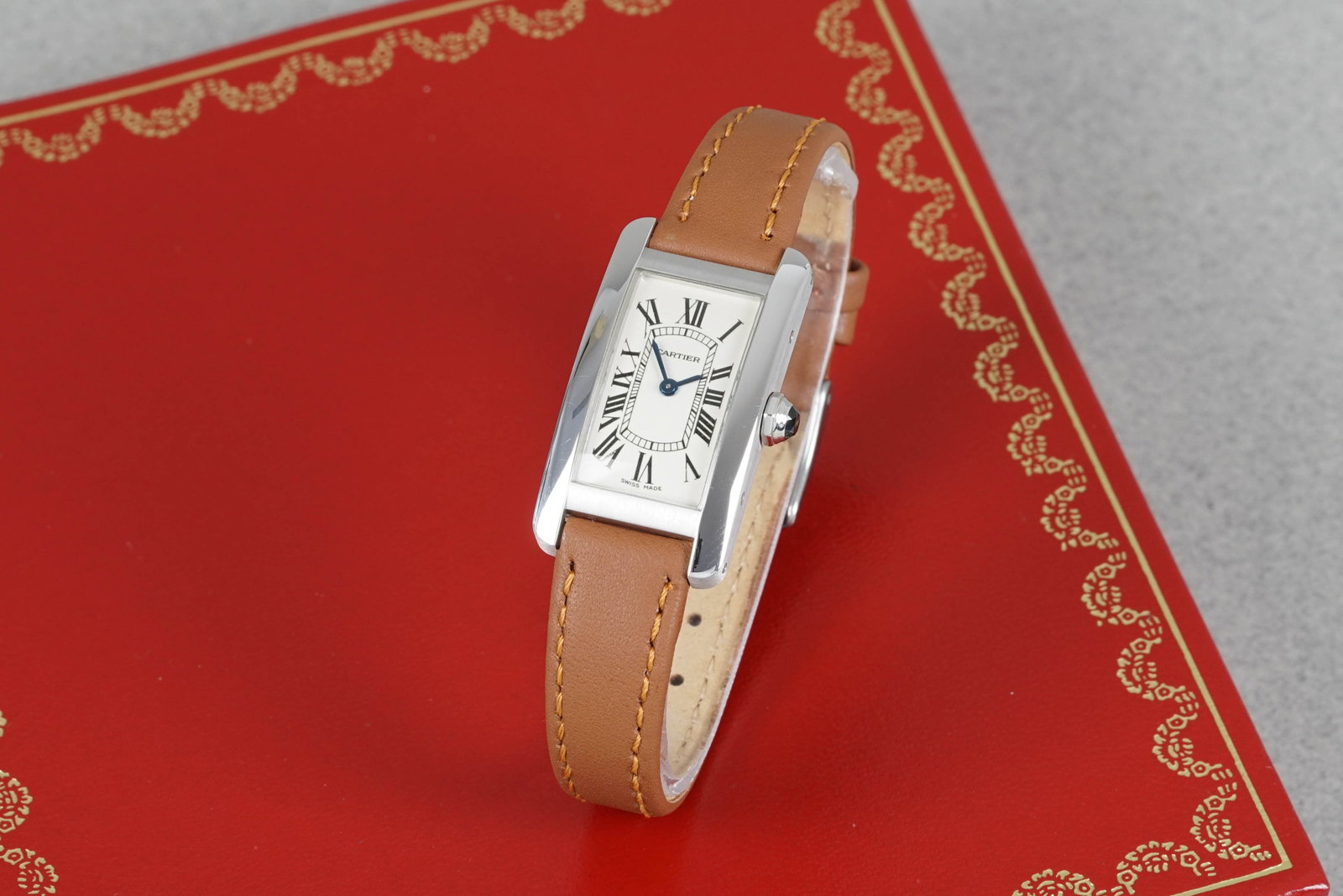 CARTIER TANK AMERICAINE 18CT WHITE GOLD W/ PAPERS REF. W2601956 CIRCA 2004: CARTIER TANK AMERICAINE 18CT WHITE GOLD W/ PAPERS REF. W2601956 CIRCA 2004, this watch is fitted with a white oblong dial with, roman numeral hour markers and blue sword hands. The 19mm 18ct white