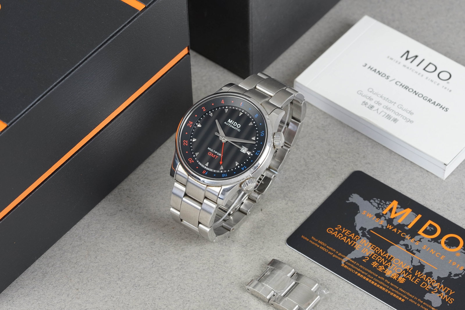 MIDO MULTIFORT GMT WRISTWATCH W/ BOX & GUARANTEE CARD REF. M005.929: MIDO MULTIFORT GMT WRISTWATCH W/ BOX & GUARANTEE CARD REF. M005.929 DIAL: Circular black dial, applied hour markers, date window, internal bezel CASE: 42mm stainless steel case, twin screw down