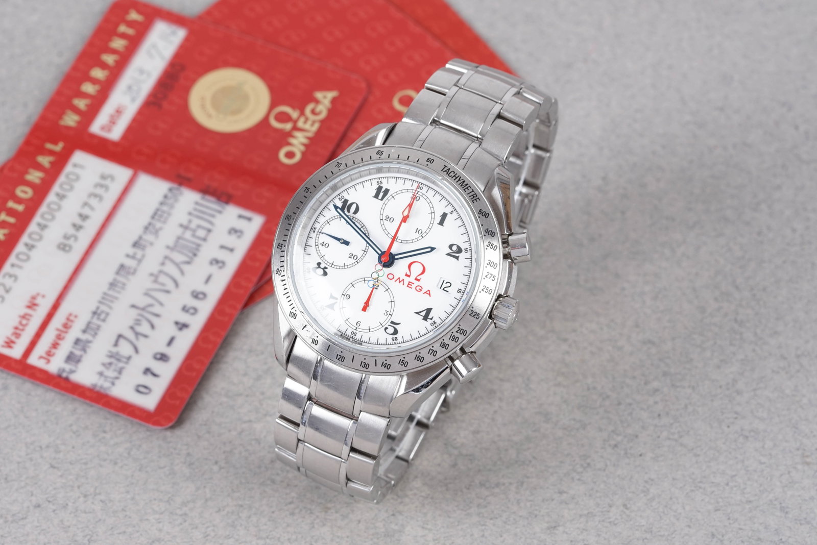 OMEGA SPEEDMASTER OLYMPIC COLLECTION W/ GUARANTEE CARD REF. 323.10.40.04.001 CIRCA 2013: OMEGA SPEEDMASTER OLYMPIC COLLECTION W/ GUARANTEE CARD REF. 323.10.40.04.001 CIRCA 2013, this watch is a ref. 323.10.40.04.001 and is fitted with a white dial with 3 sub dials, numeral hour markers