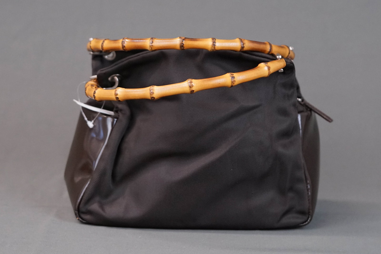 GUCCI BAMBOO BROWN NYLON HANDBAG 0575: GUCCI BAMBOO BROWN NYLON HANDBAG 0575 DIMENSIONS: Width 24cm, height 20cm, depth 9cm COLOUR: brown MATERIAL: leather and nylon ACCESSORIES: n/a CONDITION RANK: some wear commensurate with age If you