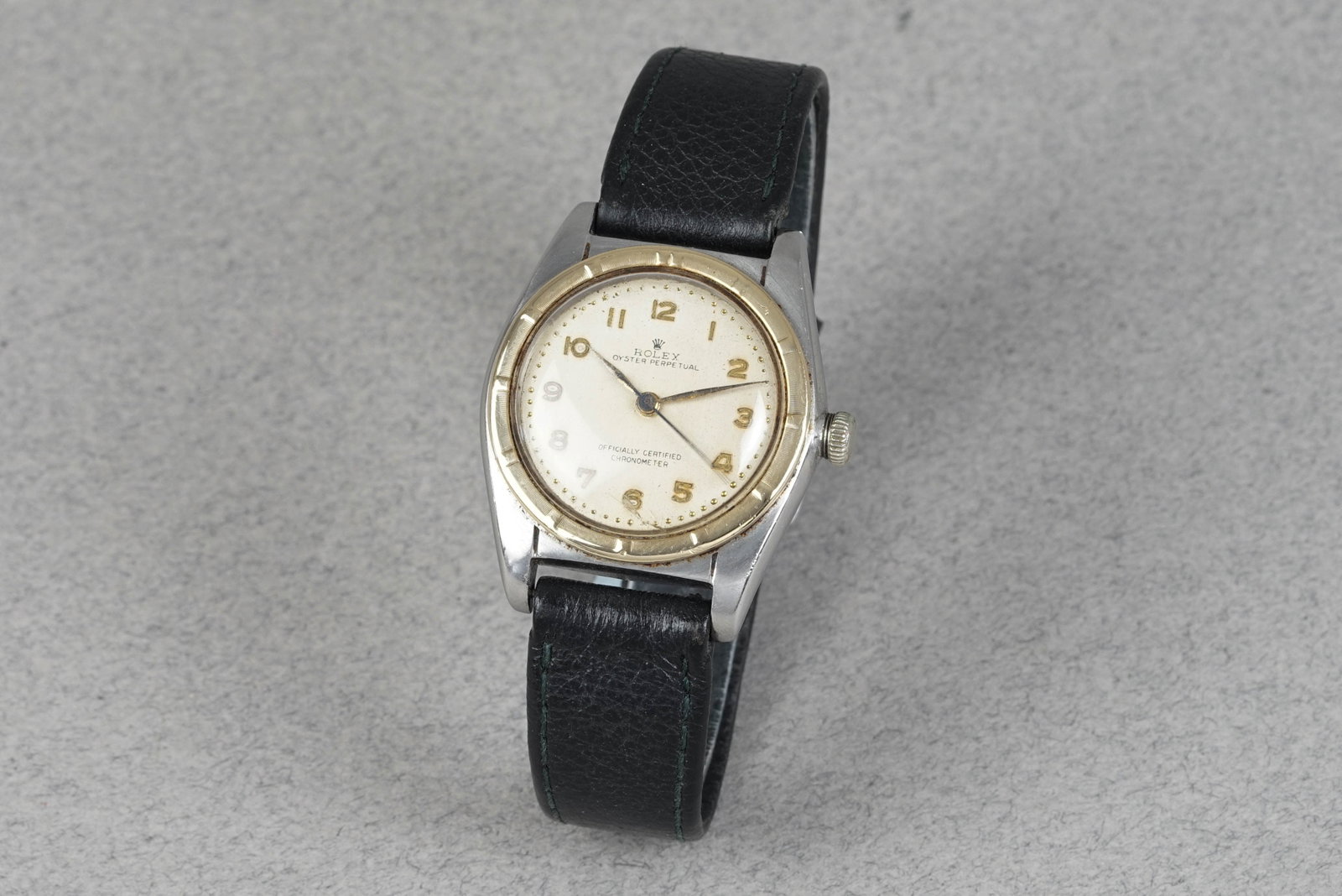 ROLEX OYSTER PERPETUAL 'BUBBLEBACK' STEEL & GOLD REF. 5015 CIRCA 1948: ROLEX OYSTER PERPETUAL 'BUBBLEBACK' STEEL & GOLD REF. 5015 CIRCA 1948 DIAL: circular patina white dial, numerical hour makers, blue steel hands, centre seconds CASE: 32mm steel case, gold engine