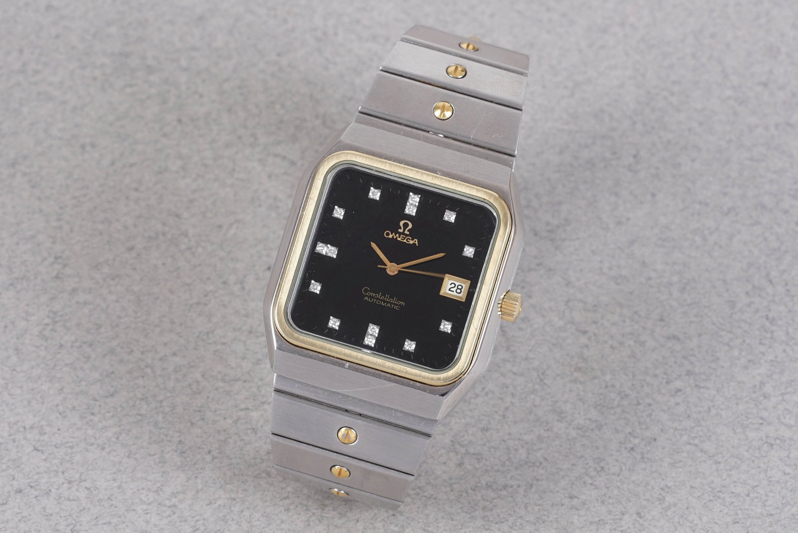 OMEGA CONSTELLATION DIAMOND SET STEEL & GOLD JUMBO AUTOMATIC WRISTWATCH: OMEGA CONSTELLATION DIAMOND SET STEEL & GOLD JUMBO AUTOMATIC WRISTWATCH and is fitted with a black square dial with date window, diamond hour markers and baton hands. The 40mm steel and gold case