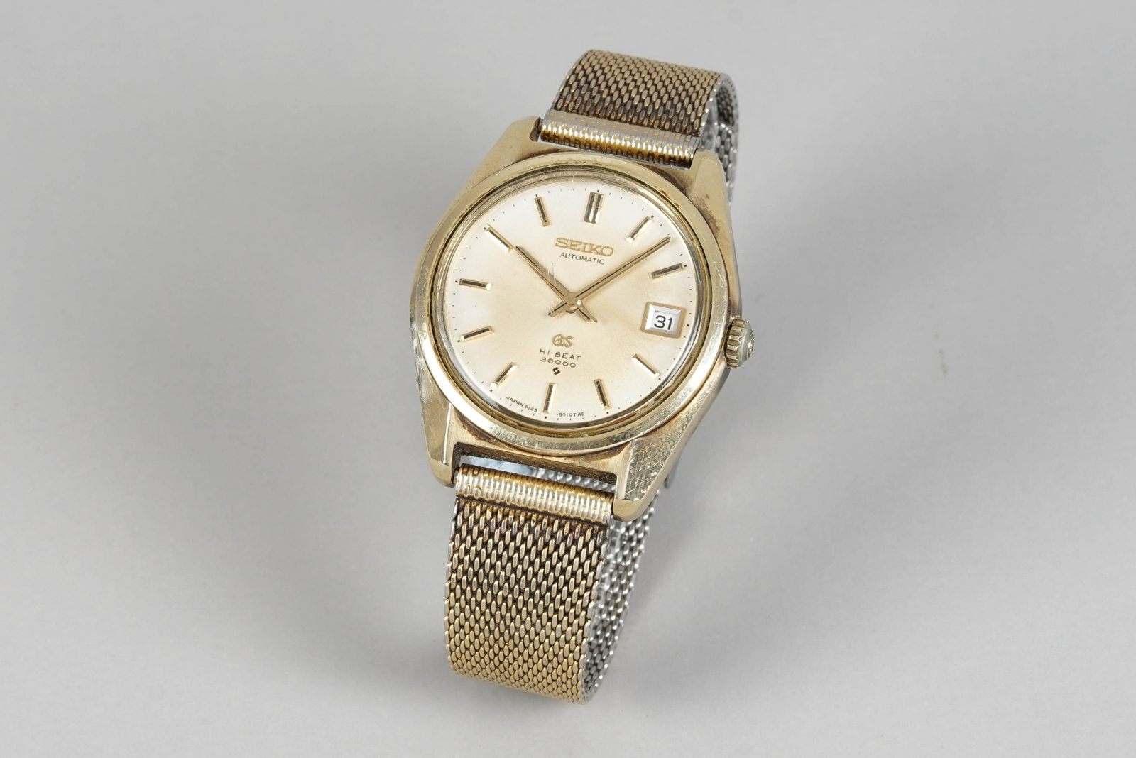 *NO RESERVE* GRAND SEIKO HI-BEAT 36000 GOLD PLATED AUTOMATIC DATE REF. 6145-8000: GRAND SEIKO HI-BEAT 36000 GOLD PLATED AUTOMATIC DATE REF. 6145-8000 DIAL: Circular patina dial, gold baton hour markers and hands, date window CASE: 37mm gold plated case, GS crown, screw down case