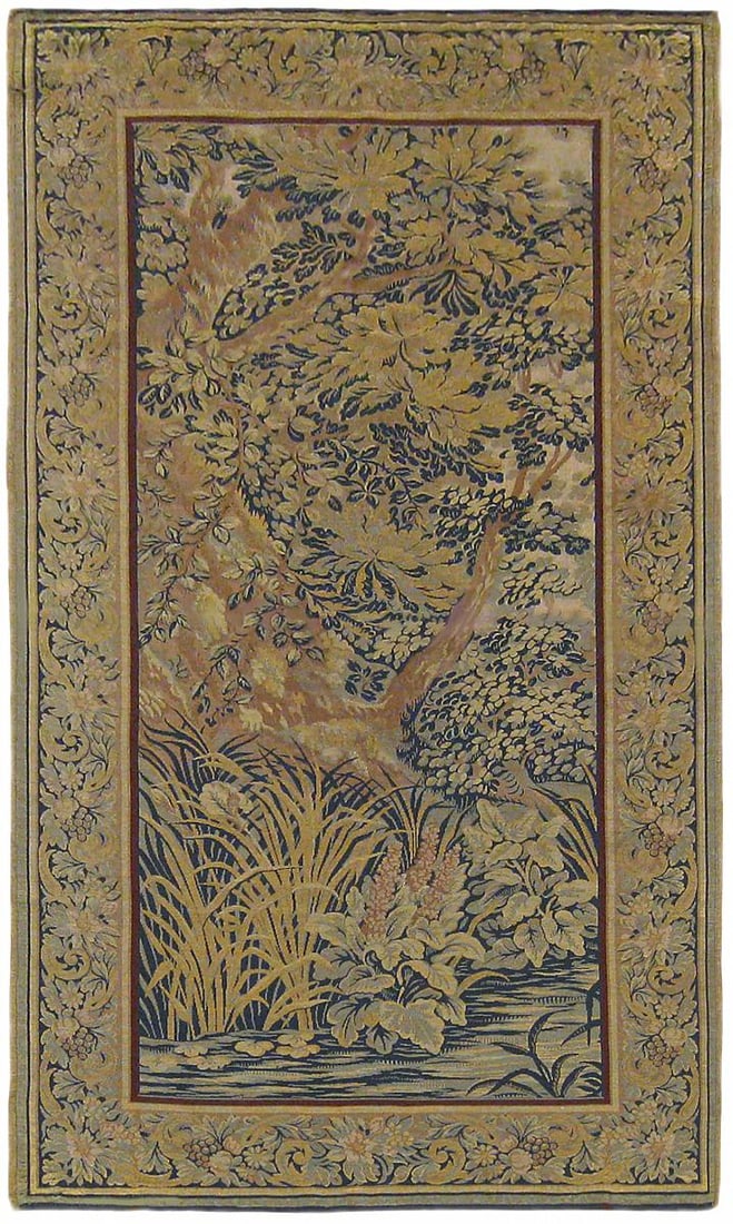 Period Antique Loomed Landscape Tapestry 6'7" H x 3'3" W: A loomed French landscape tapestry from the first quarter of the twentieth century, circa 1920, picturing a wooded area by the waterside, with various trees, bushes, and acanthus plants. Enclosed by a