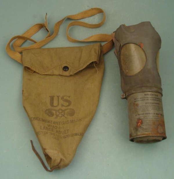 U.S. WWII NONCOMBATANT GASMASK & CANVAS BAG- M1A2-1-1: WWII NON-COMBATANT M1A2-1-1 GASMASK W/ORIGINAL OD CARRY BAG WITH SNAP AND CARRY STRAP. CANNISTER SHOWS AGE. SIZE LARGE.
