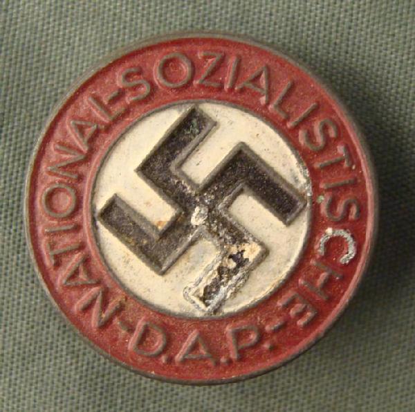 RARE VARIATION NAZI PARTY PIN. PAINTED METAL & BUTTON: MAKER MARKED M1/42 NAZI ORIGINAL PARTY MEMBERSHIP PIN. RARE VARIETY-PAINTED AND BUTTON HOLE MOUNT. LIGHT PAINT LIFTING TO ONE ARM OF SWASTIKA. JUST UNDER 1 INCH IN DIAMETER.