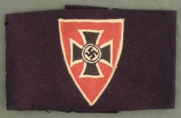 NAZI WAR SURVIVOR VETERAN ARMBAND W.SHIELD IRON CROSS: NAZI WAR SURVIVOR VETERAN ARMBAND W.SHIELD IRON CROSS & SWASTIKA + MATCHING ENAMEL STICKPIN-MARKED. ARMBAND IS BLACK WOOL WITH SATIN PATCH-HAS COUPLE OF SMALL MOTH NIPS. STICKPIN IN GOOD CONDITION