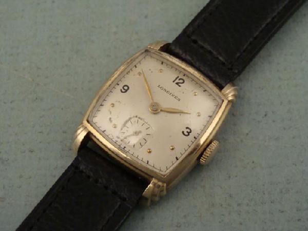 Longines Vintage Ladies Mens Barrel Shaped Watch 1940s: This is a vintage Longines wristwatch, with barrel shaped case with Art Deco styling. It is in good condition, and was running when tested. The winding is a little tight, so it may need adjustment. Th