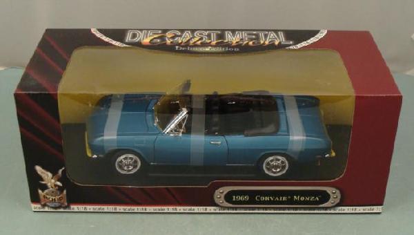 1969 Corvair Monza Convertible 1:18 Diecast Car MIB: This is a 1969 Corvair Monza Convertible from Road Signature. This 1:18 scale diecast car is metallic blue with black interior, white wall tires, and opening doors, engine compartment, and hood. It is