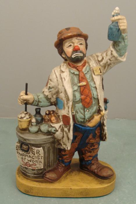Dave Grossman Hobo Clown Pharmacist Doctor Figurine: This hobo clown has a little pharmacy business going, mixing up some medicinals. Artist Dave Grossman created this funny porcelain figurine. It measures 9" tall x 5 1/2" wide. Its condition is excelle