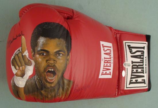Muhammad Ali Signed Ken Branch Handpainted Boxing Glove: This boxing glove not only has an original signature by Muhammad Ali, it also has a remarkable hand-painted portrait of "The Greatest". The artwork was done by Ken Branch, and the brilliant detail rea