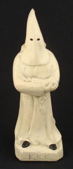 1923 KKK PLASTER STATUE OF KLANSMAN REPRO: THIS IS A REPRODUCTION OF A1923 KU KLUX KLAN (KKK) KLANSMAN STATUE. IT IS 8" TALL. THIS PIECE HAS GREAT DETAIL OF A HOODED KKK MEMBER. THERE IS A FLOWING CAPE IN BACK AND A RED TASSEL ON TOP OF HOOD.