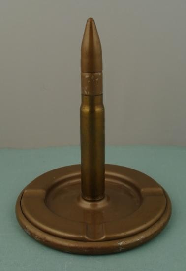 GENUINE 20MM WWII SHELL LIGHTER & ASHTRAY BRASS: THIS IS A WWII GENUINE 20MM CANNON CARTRIDGE CASE-LIGHTER AND ASHTRAY-MFG SOUVENIR. MARKED ON THE BOTTOM IS: STONER MFG CORP - AURORA, IL. IT IS 8" TALL AND MADE OUT OF BRASS AND PAINTED METAL. HAS BE