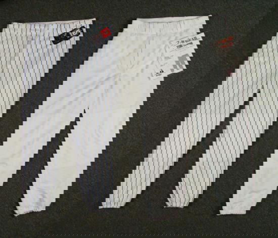 2 Baseball Pants- Blue Stripe Wilson/White Badger Sport: These are two brand new baseball pants. One is a Wilson A4160, white w/royal blue stripes and is a size large. (measures 34 inches around). The other is a large, all white Badger Spor