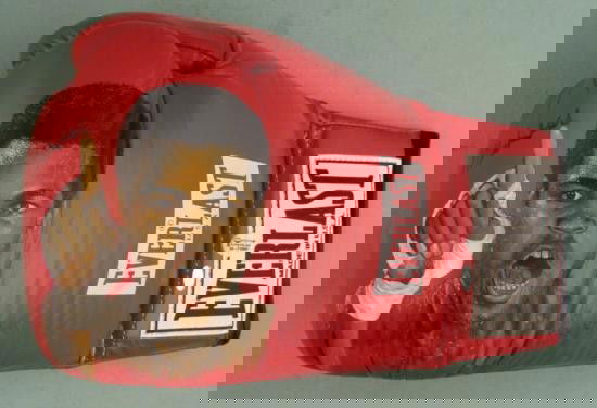 Muhammad Ali Signed Ken Branch Handpainted Boxing Glove: This boxing glove not only has an original signature by Muhammad Ali, it also has a remarkable hand-painted portrait of "The Greatest". The artwork was done by Ken Branch, and the brilliant detail rea