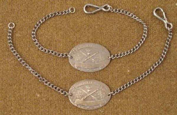 Pair (2) French WWII Artillery Unit Bracelets La Legion: Here is a pair of WWII era bracelets from a French Artillery unit. They are metal with an image of rifles and bomb. There is one blank banner, and one banner with the words: HONNEUR A LA LEGION. The p