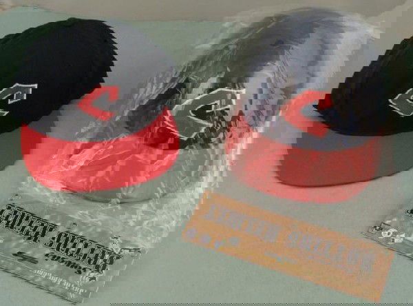 Cleveland Indians Throwback Hat, Batting Helmet New: Here are two great Cleveland Indians Throwback items, with their old logo. One is a cotton cap, fitted size 6 7/8. There is a plastic batting helmet, and its adjustable to about 22" in circumference.