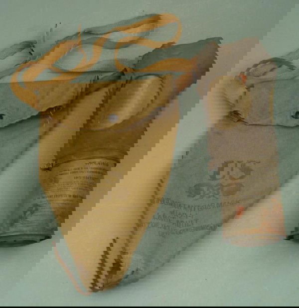 U.S. WWII NONCOMBATANT GASMASK & CANVAS BAG- M1A2-1-1: WWII NON-COMBATANT M1A2-1-1 GASMASK W/ORIGINAL OD CARRY BAG WITH SNAP AND CARRY STRAP. CANNISTER SHOWS AGE. SIZE LARGE.