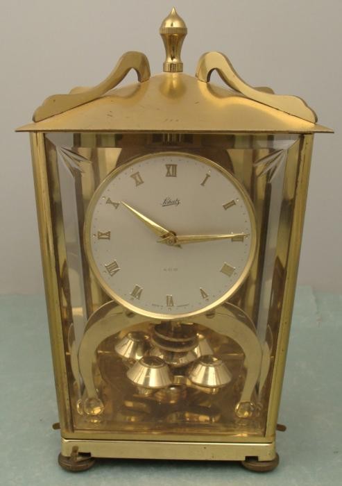 Schatz 400 Vintage Brass German Anniversary Shelf Clock: This is a vintage Schatz 400 Clock made in Germany. It is in very good physical condition, with a fine sheen. Mechanically it needs some attention to get it running. The wire that attaches