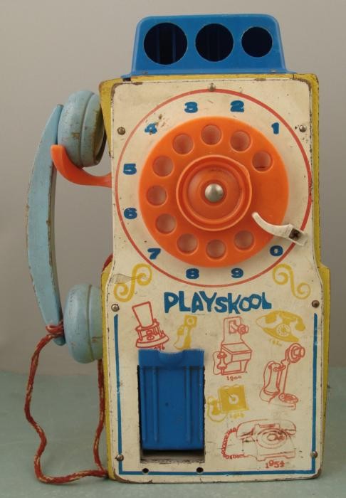 Playskool Vintage Wooden Telephone Toy Pay Phone: This toy telephone from Playskool is vintage 1970's, and it has images of even older phones on front. The rotary dial works and returns fine, and the original string phone cord is intact. Ther