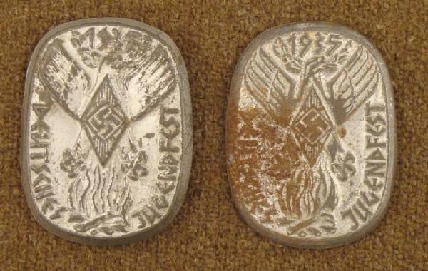 2 DJ/DEUTSCHES JUGENDFEST BADGES 1935-W/HJ SWASTIKAS: 2 ORIGINAL DJ/DEUTSCHES JUGENDFEST BADGES FROM 1935-W/HJ SWASTIKAS IN DIAMOND RALLY CONCLAVE BADGES. SILVER-TONED STAMPED METAL.