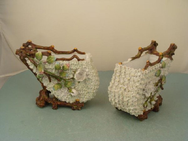 2 Capodimonte Style Porcelain Vintage Flower Carts: This pair of porcelain flower carts is adorned with delicate flowers, leaves, and structure that looks like they were made out of twigs. The style is like Capodimonte, although we find no marks or sti
