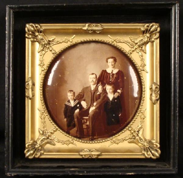 Antique Family Portrait Photo Bubble Glass 1920s Framed: This portrait is an antique, and it portrays a family, with boys in sailor outfits. It is sepia tone, with some spotting. It is in a gold tone ornate frame, inside a black painted wood shadow box. The