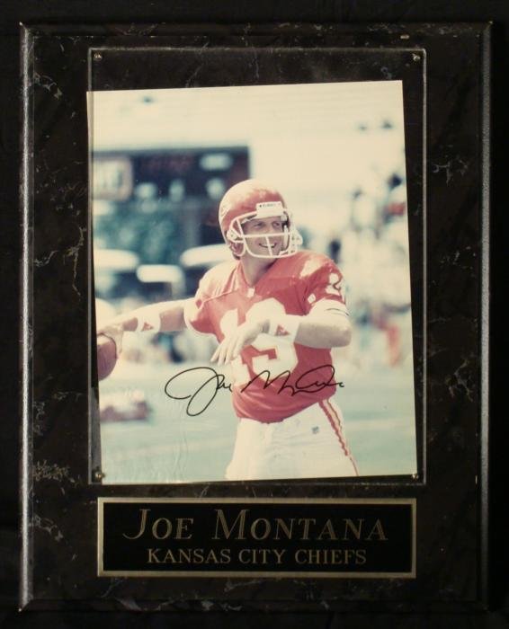 Joe Montana Signed NFL Photo Plaque KC Chiefs: This is Joe Montana signed 8 x 10 photo plaque from his one season with the Kansas City Chiefs. The autograph is in black Sharpie. It has a Plexiglass cover on a charcoal marble pattern wood plaque, 1