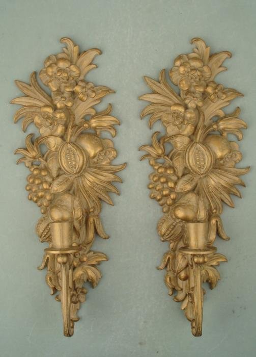 Pair Durawood Vintage Gold Painted Wall Candle Holders: This pair of wall candle holders features lush designs in wood, all painted in antiqued gold. Each is 6 1/2" x 17", and can hold 7/8" diameter candles. The back sides have maker labels. These were mad