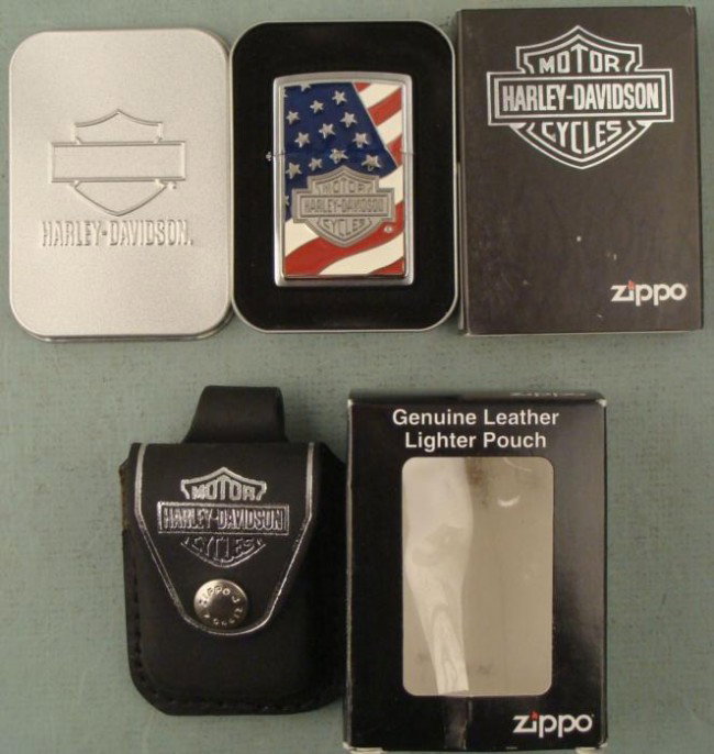 Zippo Harley Davidson Americana Flag Lighter, Pouch MIT: This is a Zippo Harley Davidson lighter plus a pouch, both in Mint condition. The lighter is model 20685 Americana, with flag and Harley logo. It comes in a tin and sleeve. The pouch is black leather 