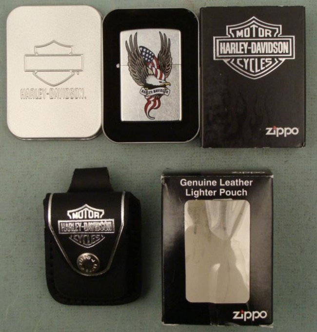 Zippo Harley Davidson Eagle Lighter & Pouch New Mint: This is a Zippo Harley Davidson lighter plus a pouch, both in Mint condition. The lighter is model 21073 Eagle Americana, with full color eagle. It comes in a tin and sleeve. The pouch is black leathe