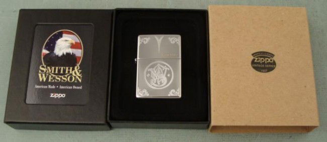 Zippo Smith & Wesson 1937 Rep Lighter Ltd Ed New Mint: This is a Smith & Wesson 1937 replica Zippo lighter, model 24214. It is a limited edition, numbered 1259/5000. It is high polish chrome, and features the old "Smith & Wesson" logo engraved on