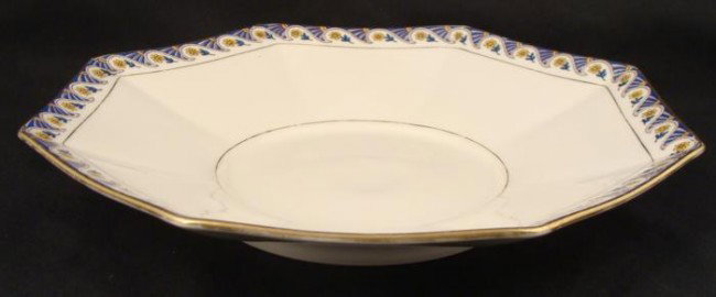 Limoges Art Deco Bowl U.C. France: This Limoges bowl has a pattern reflective of Art Deco styling, in red, yellow and blue, with waves and flowers, and gold trim. The bowl was made in France exclusively for Marshall Field & Company
