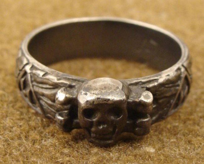SS TOTENKOPF H. HIMMLER HONOR RING ENGRAVED 925 SILVER: IMPRESSIVE NAZI SS TOTENKOPF HONOR RING-TAISED TOTENKOPF SKULL & CROSSBONES AND RUNIC SYMBOLS AROUND RING- SILVER-INSIDE ENGRAVED WITH H. HIMMLER SIGNATURE AND "925" (STERLING SILVER). PERIOD ?-
