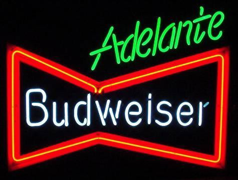 Budweiser Adelante Mexican Soccer 3 Color Neon Sign: Here is an Adelante Budweiser neon sign. This slogan ran in Mexico, and was featured at soccer matches. This sign features the traditional bow tie logo, in true red neon with plastic backing, white ne