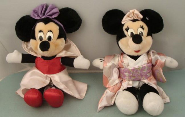 2 Minnie Mouse 15 Plush Dolls Disney World Disneyland: These two 15" tall Minnie Mouse plush dolls are from a Disney theme park store from over 10 years ago. Each wears a dazzlingly different costume, one in traditional pink and red, and the other in a si