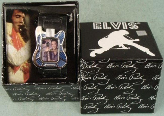 Elvis Presley Guitar Shaped Picture Watch EV-W07A MIB: Here's Elvis Presley with his guitar, on the face of a watch that's shaped like an Elvis guitar! This terrific watch has a full color photo image, chrome tone hands, and chrome and denim blue body. It