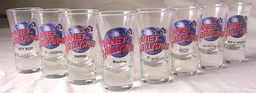 8 Planet Hollywood Orig Shot Glass Boston Hamburg: This is a lot of 8 RARE shot glasses from Planet Hollywood. All but one are from closed locations! They are in mint, never used condition. Each 3 1/2" tall flared glass features the blue globe and red