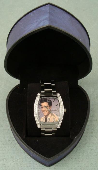 Elvis Presley Rhinestone Picture Watch EV-W02A MIB: This is a classic Elvis picture watch, with a photo image portrait from his Army days. The watch has chrome tone hands, and chrome tone body, and has elegant rhinestones on the sides. It comes in a co
