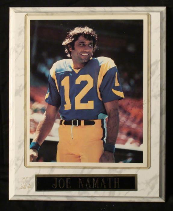 Joe Namath Signed Football Portrait Photo Plaque: Football legend Joe Namath signed this 8 x 10 photo on a plaque, along with a message: "Ken, Thanks for your support. Best Wishes." The autograph and writing is in black ballpoint. The photo is in a p